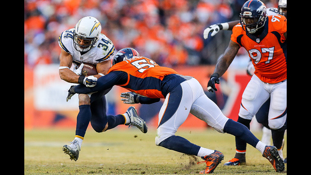 DENVER, CO - JANUARY 3: Running back Donald Brown #34 of the San Diego Chargers is hit by linebacker Shane Ray #56 of the Denver Broncos as he rushes during a game at Sports Authority Field at Mile High on January 3, 2016 in Denver, Colorado. (Photo by Justin Edmonds/Getty Images)
